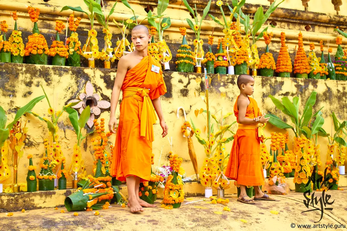 Young monks help elder to collect offering of parishioners during Pha That Luang Festival, Pha That Luang, Vientiane, Laos.